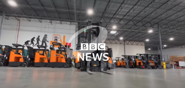 BBC News logo over an image of forklifts in the Fox Robotics warehouse in Austin, TX